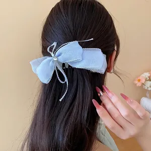 Elegante horquilla de lazo de encaje azul claro con adorno de estrella en el pelo