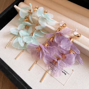 Detail showing the delicate floral mesh petals and tassels of these Mori style earrings