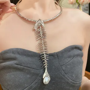 Detailed view of an oversized silver fishbone choker necklace with a large pearl pendant