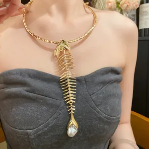Close-up of vintage gold fishbone choker necklace with elegant pearl pendant