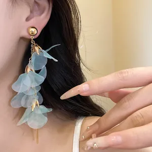 Elegant long tassel earrings featuring light blue mesh flower petals on model detail view