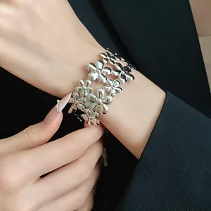 Detailed view of elegant silver-toned double layer floral open cuff bracelet on wrist