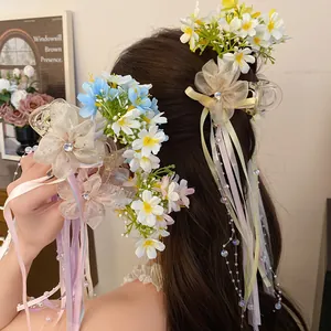Close-up detail of ballet style flower hair clip with colorful silk ribbons on model's hair
