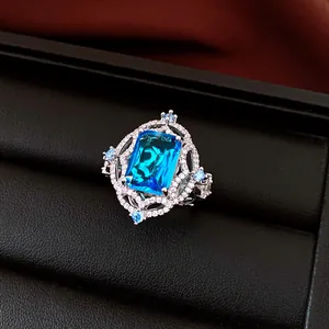 Detailed view of a vintage palace style silver ring with a large blue cubic zirconia.
