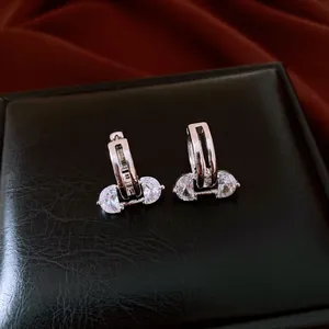 Close-up of elegant 18K silver plated zircon earrings with hollow oval design