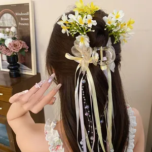 Close-up detail of balletcore hair claw clip with colorful silk ribbons and delicate flowers
