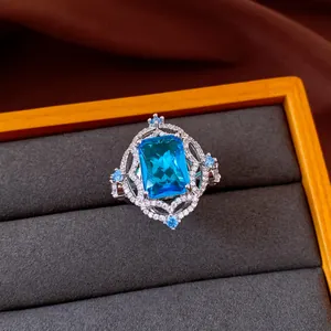 Detailed view of a vintage rectangular blue zircon ring inside a luxury velvet jewelry box