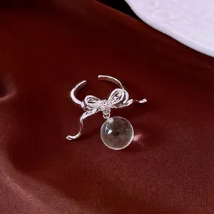 Elegant silver bowknot open ring featuring zircon inlay and a clear resin ball pendant