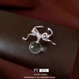 Elegant minimalist silver bow ring with zircon and a suspended clear resin sphere