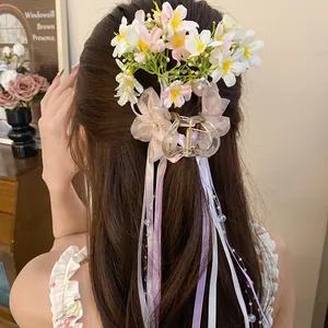 Detailed view of balletcore flower hair claw clip with long lavender and white ribbons