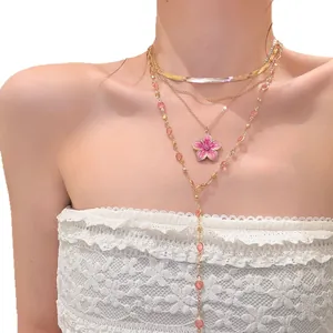 Elegant multi-layer gold-tone necklace with pink flower pendant and delicate beads for women