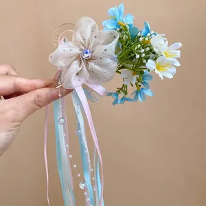 Delicate detail of ballet style hair clip with pastel ribbons and fabric flower