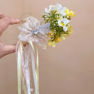 Exquisite detail view of a ballet style hair clip featuring a flower and long pastel ribbons