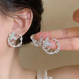 Close-up of zircon butterfly stud earrings showing intricate sparkle and delicate design