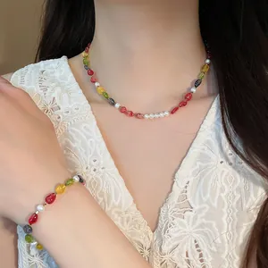 Close-up detail of a colorful bead and pearl necklace and bracelet jewelry set for women