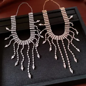 Detail view of gold and silver rhinestone necklaces with elegant waterdrop tassels.