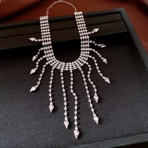 Elegant silver rhinestone tassel necklace with teardrop crystals on black display