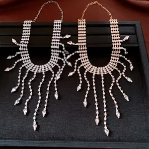 Detail of silver and gold rhinestone tassel necklaces with teardrop pendants