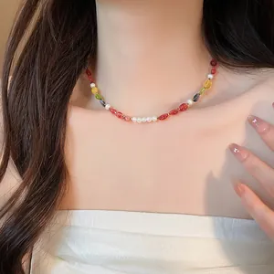 Detail shot of a vibrant colorful beaded necklace with pearls on a woman's neckline