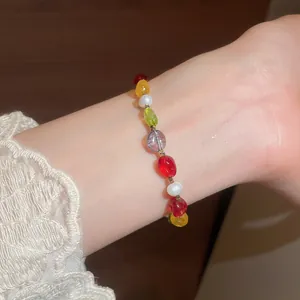 Detailed view of a dopamine style colorful stone beaded bracelet with pearls on a wrist
