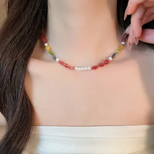 Detailed close-up of a vibrant multi-color stone beaded necklace with pearls on neck