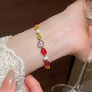 Detailed close-up showing a dopamine colorful stone and pearl beaded bracelet on a wrist