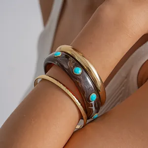 Close-up of vintage 3-piece resin marbled bangles with turquoise-tone studs.