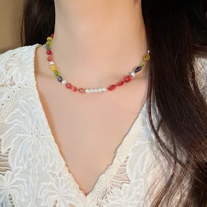Detailed view of a colorful beaded necklace with freshwater pearls worn by a model