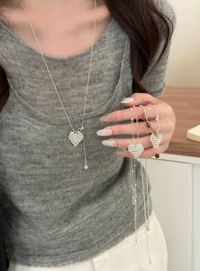 Close-up detail of silver beaded heart pendant necklace with adjustable pull chain