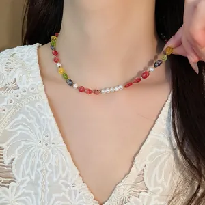Elegant colorful beaded stone necklace with white pearls shown on a model close-up view