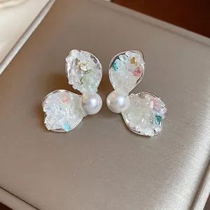 Elegant French style pearl stud earrings with iridescent crushed stone petal wings