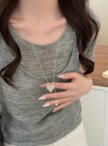 Elegant silver beaded heart pendant necklace shown on model with adjustable drawstring chain