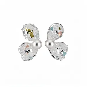 Elegant silver butterfly wing stud earrings with crushed stones and central pearl.