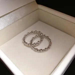 Minimalist silver-tone lace rings with sparkling zircon stones in a white jewelry box