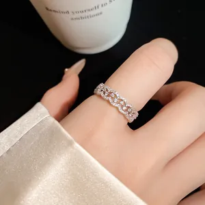 Detailed view of elegant silver lace ring with sparkling zircon pavé on a finger
