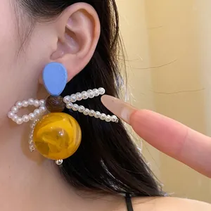 Unique vintage handmade wood resin pearl bow drop earrings for an elegant aesthetic look