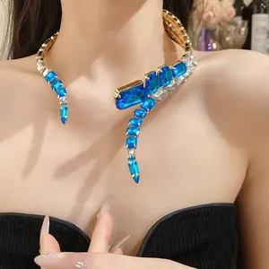 Close-up of vintage choker featuring large blue and clear square crystals in gold.