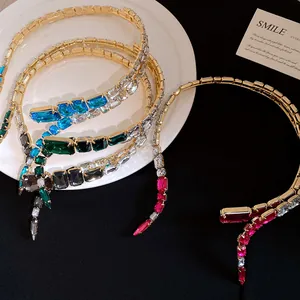 Close-up of vibrant rectangular crystals on multiple gold-tone open choker necklaces.