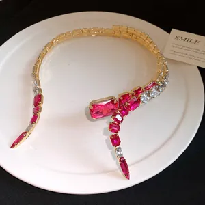 Close-up of luxury gold choker necklace featuring pink and clear square rhinestones