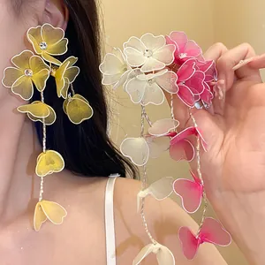 Close-up of elegant silk mesh floral tassel earrings with sparkling rhinestone accents
