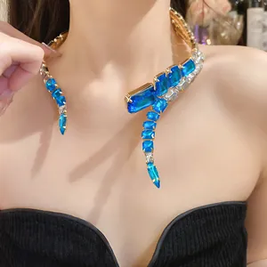 Detailed view of an elegant gold choker with vibrant blue and clear square crystals