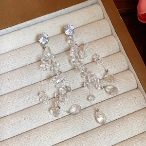Elegant detail showing sparkling zircon and clear glass waterdrop tassel earrings on display