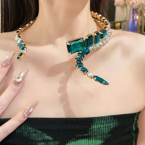 Detailed close-up showing the sparkling emerald gemstones of this elegant gold snake choker.