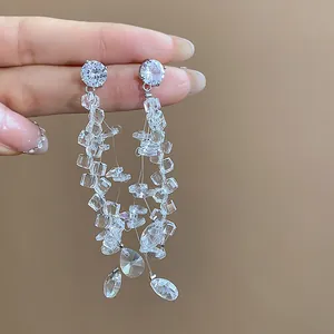 Detailed macro view of elegant cascading glass bead tassel earrings with faceted teardrop pendants
