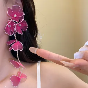 Detailed view of pink mesh flower tassel earrings with sparkling rhinestones