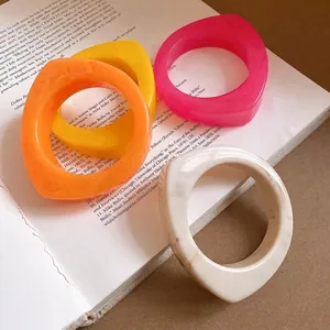 Chic geometric marbled resin bangles in vibrant colors for a unique fashion statement