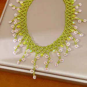 Detailed view of handcrafted green and pink floral beaded bohemian style necklace