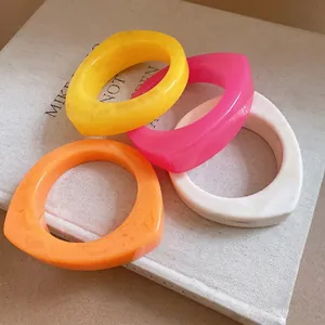 Colorful chunky geometric resin bangles with a curved niche design for women