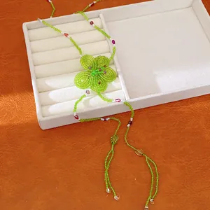 Detailed macro view of a forest style green beaded flower necklace for summer vacation