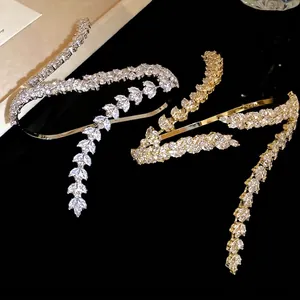 Elegant cubic zirconia wheat ear cuff bracelets in silver and gold on a sleek black base